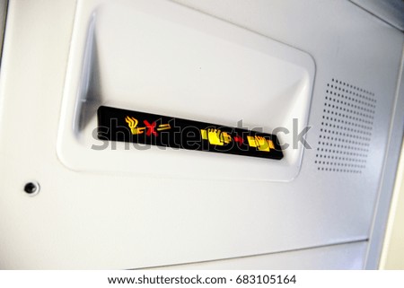 photo of No Smoking and Fasten Seat belt Sign Inside an Airplane