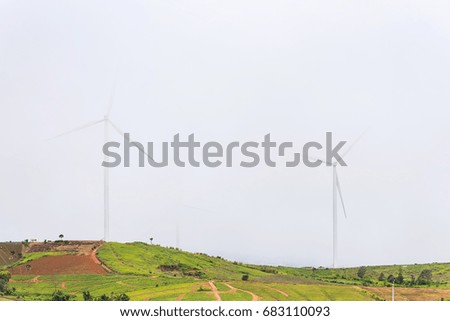 Power of wind turbine generating electricity clean energy with mist fog background.Global ecology.Clean energy concept save the world
