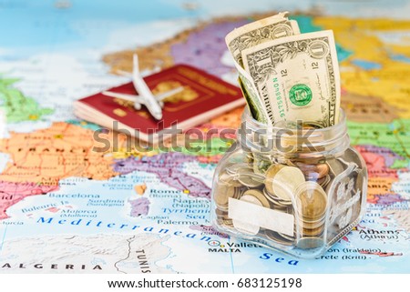 Holidays money savings in a glass jar with passport and aircraft toy on world map, copy space, mock up, holiday concept Royalty-Free Stock Photo #683125198