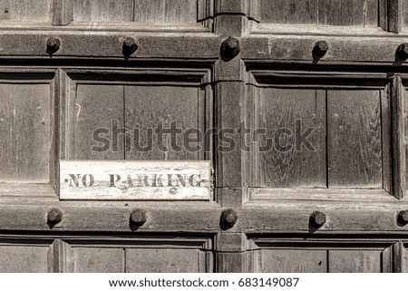 No parking sign on wooden door, England