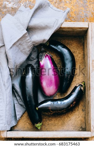 Fresh eggplants in a wooden box, aubergine harvest