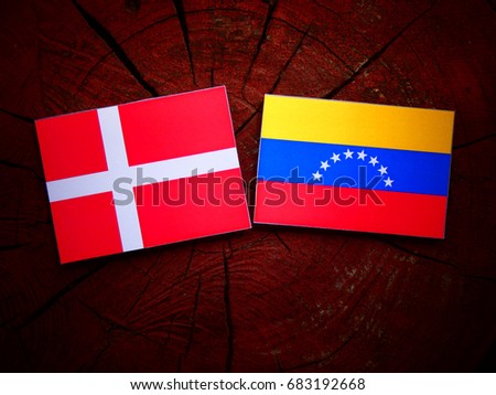 Danish flag with Venezuelan flag on a tree stump isolated