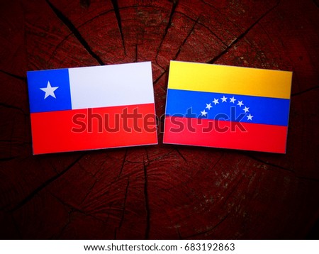 Chilean flag with Venezuelan flag on a tree stump isolated