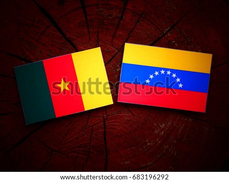 Cameroon flag with Venezuelan flag on a tree stump isolated