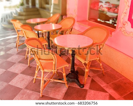 View of the cafe on the street outside with an empty table. Patio with a cozy romantic little restaurant for seven. Vintage style