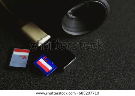 top view for workplace photographer. memory cards , card reader USB 3.0 on desk with over light and soft-focus in the background
