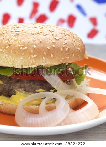 a classic burger served in a plate with a festive background