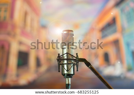 Condenser microphone with blue bokeh background.High quality microphone standing on  karaoke stage ready for joyful christmas party