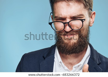 Business man in glasses on a blue background portrait                               