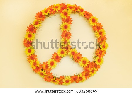 Retro styled image of a seventies flower power peace sign made out of flowers