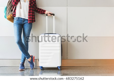 Young woman wearing casual clothes is posing at airport Royalty-Free Stock Photo #683275162