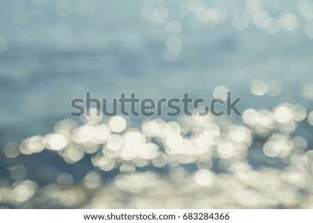 Abstract blurred background with reflected light and boke on the sea.