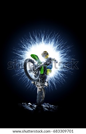 Professional dirt bike rider isolated on black background