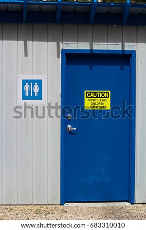 A multi-gender bathroom with a do not leave children unattended warning.
