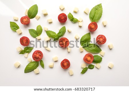 Tomatoes, cheese, Basil on a white background. Ingredients for pizza. Cute simple background, backdrop products of small size. Top view. Close-up. Stock photo Cooking concept. 