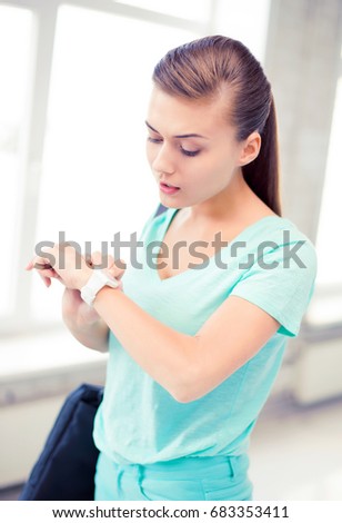 picture of surprised student girl looking at wristwatch