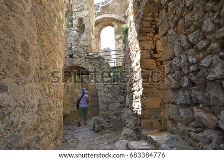 Women walking through a portal in a ruin , picture from the Northern Cyprus.