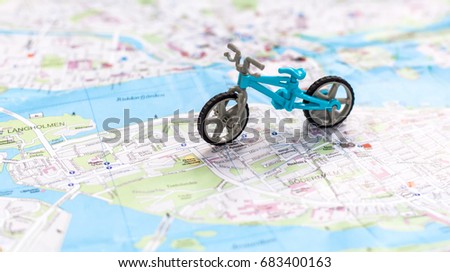  Model of a bicycle on a map background. Travel and adventure, sport concept.