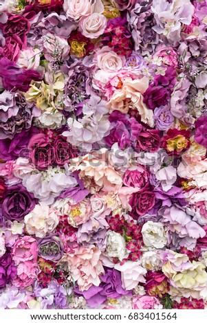 Flower texture background for wedding scene. Roses, peonies and hydrangeas, artificial flowers on the wall.