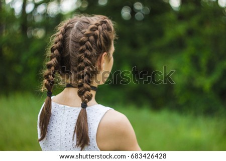Hairstyle French pigtails on the girl Royalty-Free Stock Photo #683426428