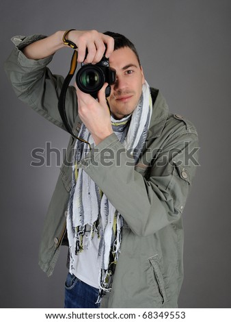 professional male photographer taking picture . isolated on gray background