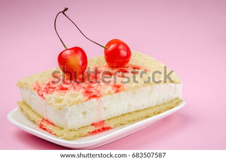 wafer ice cream with two sweet cherry and syrup/wafer ice cream with two sweet cherry and syrup on a pink background