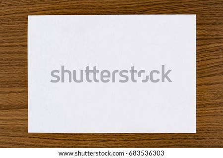 an empty sheet on a wooden surface