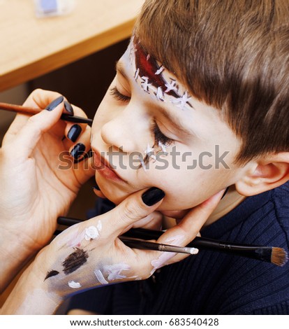 little cute child making facepaint on birthday party, zombie Apo