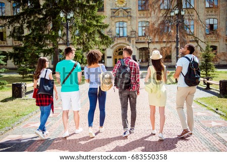 Rear view of six students, bachelor`s campus life rhythm. They are walking after to college building and discuss the project, gesturing, sharing the ideas Royalty-Free Stock Photo #683550358
