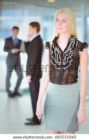 Happy businesswoman holding a paper.