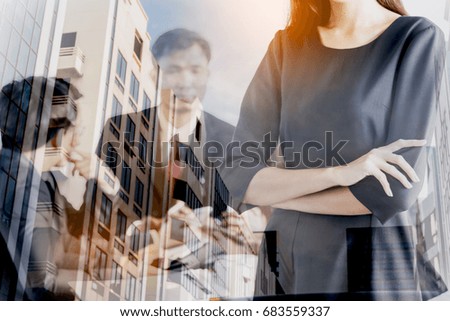 Business woman on blur office building background - Double exposure photo
