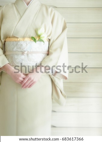 The lady puts on a kimono      Royalty-Free Stock Photo #683617366