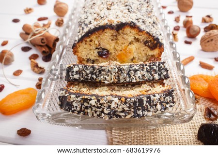 Pieces of fresh baked homemade fruitcake on boards, delicious dessert concept