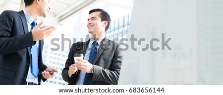 Friendly businessmen talking outdoors while going to work in the morning - panoramic web banner background with copy space