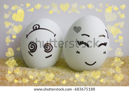 Eggs are cheerful with a face. Two pieces. Concept merry fellow. Photo for your design Frame of hearts. love
