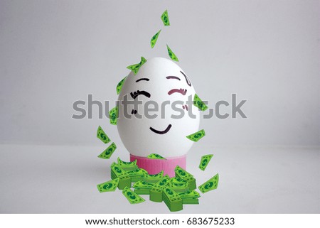 Concept of profit. Dollars stacks of money from above. Egg cheerful with face alone on white background concept of cute smile. Photo for your design