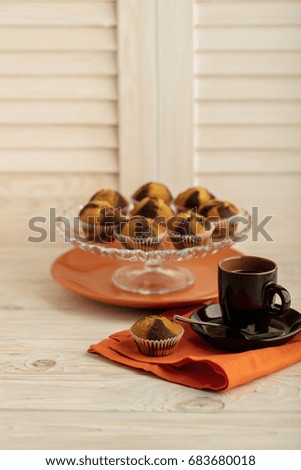 Coffee with muffins on a light wooden background. Selective focus