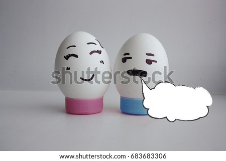 White cloud of thought is empty. Place under the text. Eggs cheerful with two face on white background on stand concept date. Photo for your design
