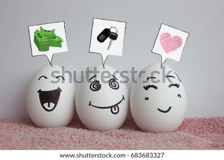 Concept of the idea of earning. Startup. Eggs are funny with faces. Concept of laughter. Photo for your design on a white background