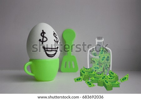 Eggs with face. Concept of love of money dollars. At breakfast make money. business. Photo for your design. Glass bank with dollars. Security finance concept