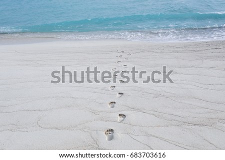 Human footprints on beach sand at resort
