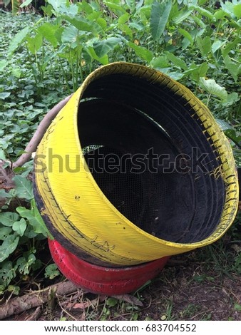 The tires were painted yellow and red. Was converted into a potted plant