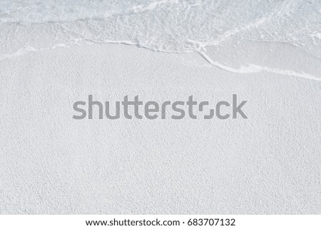 Warm sand and sea waves on beach at resort