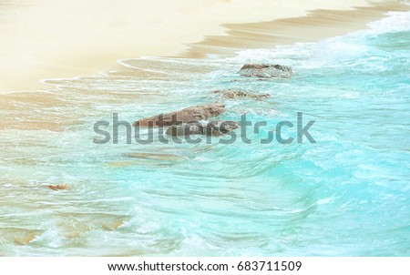 Warm sand and sea waves on beach at resort