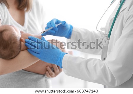 Doctor vaccinating cute baby in hospital Royalty-Free Stock Photo #683747140