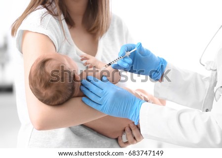 Doctor vaccinating cute baby in hospital Royalty-Free Stock Photo #683747149