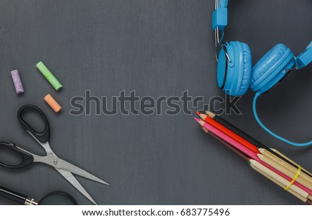 Top view stationery equipment on grunge blackboard background.Items or accessories to back to school or education concept.flat lay and copy space. 