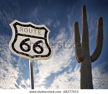 Route 66 road sign with Saguaro Cactus and wild dramatic sky Royalty-Free Stock Photo #68377615