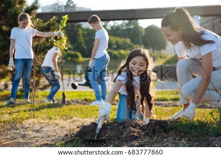 Joyful kids watering new tree Royalty-Free Stock Photo #683777860