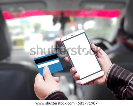 hand hold credit card and smart phone over taxi